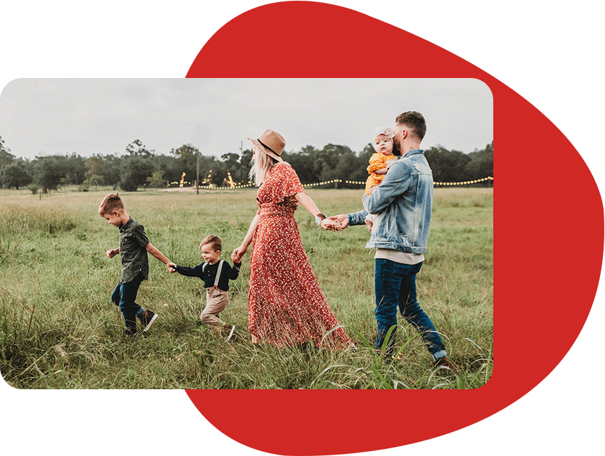 Image of a beautiful couple with their children walking at the paddy field